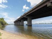 A small beach below the remaining portion of the Francis Scott Key Bridge is seen, Tuesday, Aug. 13, 2024, in Turner Station, Md. The water is unsafe for swimming and fishing from decades of industrial pollution.