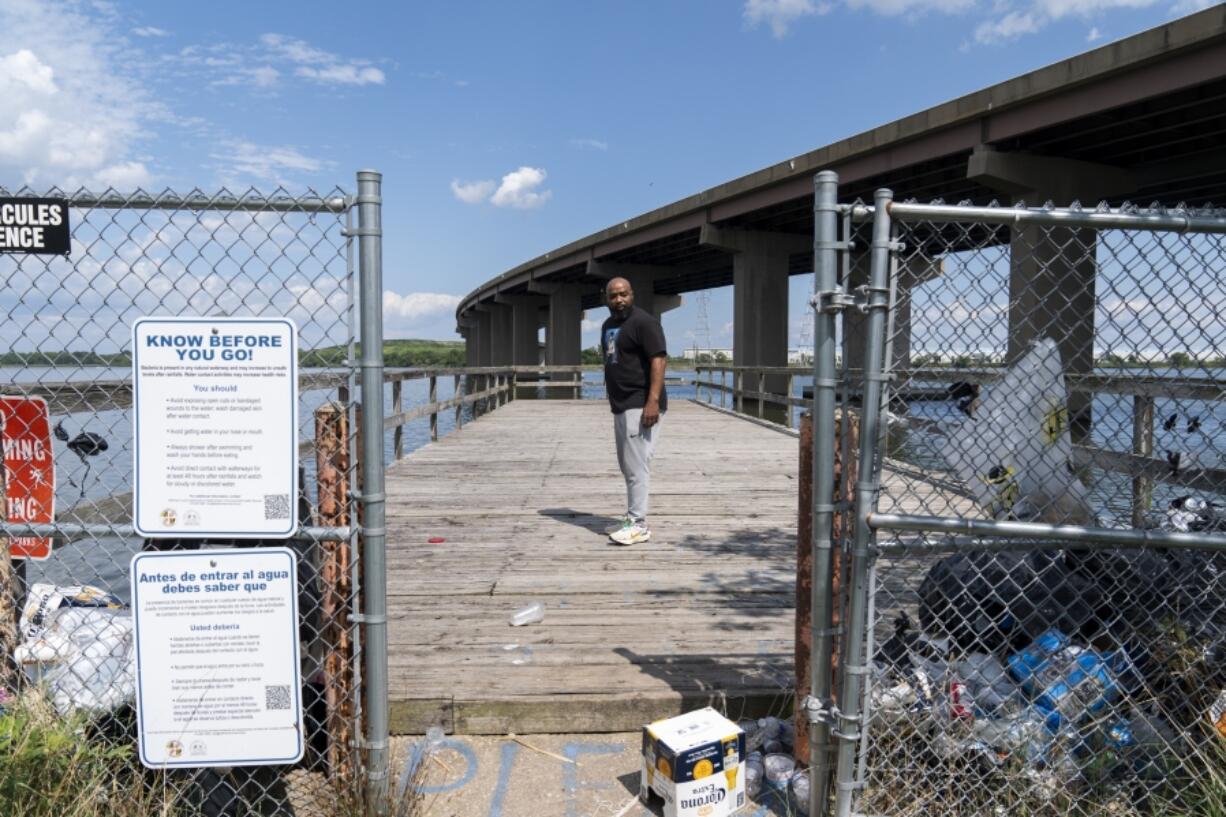 Turner Station resident Marquis Neal looks toward garbage that has piled up on a pier at Fleming Park in Turner Station, Md., Tuesday, Aug. 13, 2024.