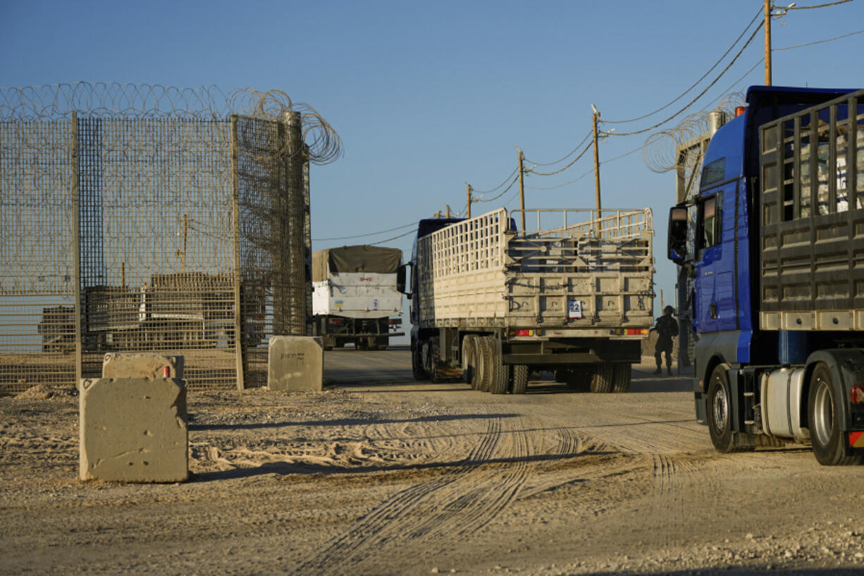 CORRECTS FROM SOUTHERN ISRAEL TO NORTHERN - Trucks carrying humanitarian aid cross into the Gaza Strip from Erez crossing in northern Israel, Monday, Oct. 21, 2024.