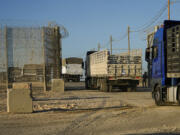 CORRECTS FROM SOUTHERN ISRAEL TO NORTHERN - Trucks carrying humanitarian aid cross into the Gaza Strip from Erez crossing in northern Israel, Monday, Oct. 21, 2024.