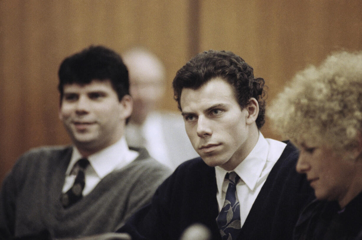 FILE - Lyle, left, and Erik Menendez sit with defense attorney Leslie Abramson, right, in Beverly Hills Municipal Court during a hearing, Nov. 26, 1990.