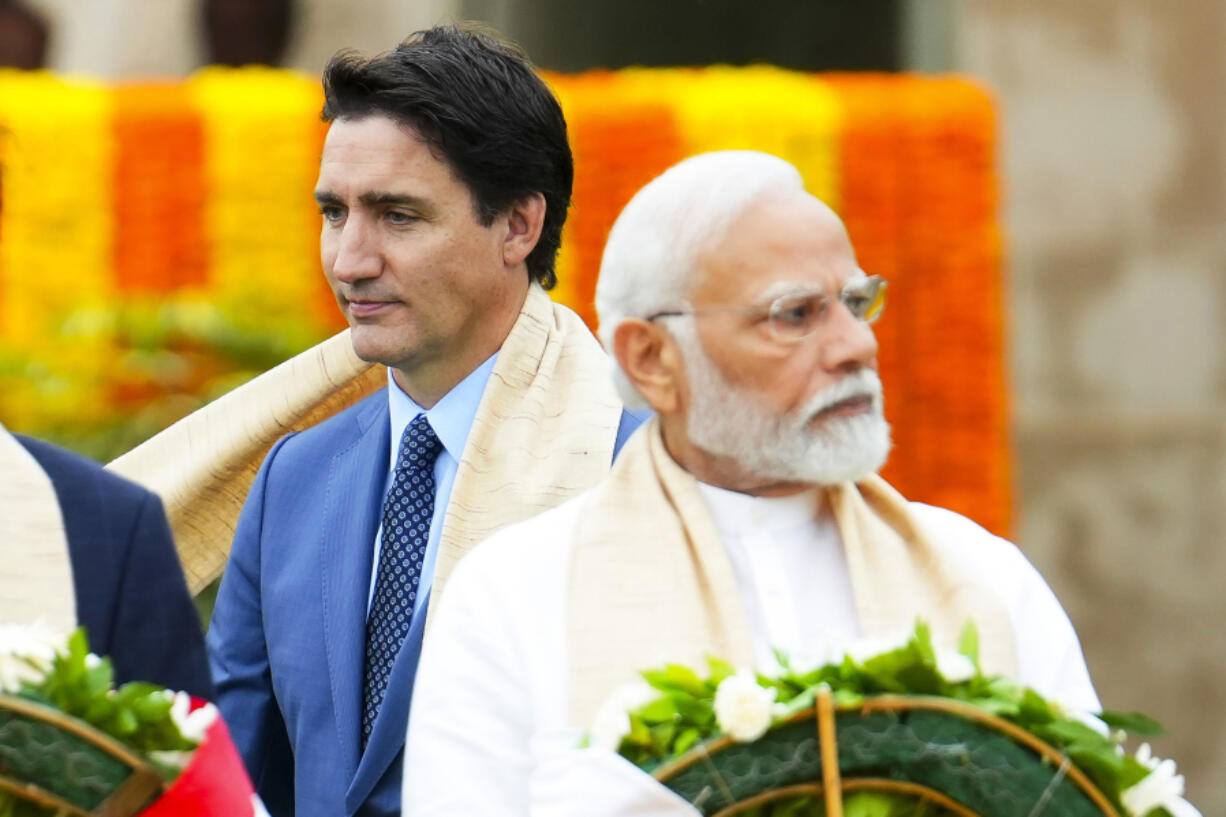 FILE - Canada&rsquo;s Prime Minister Justin Trudeau, left, walks past India&rsquo;s Prime Minister Narendra Modi as they take part in a wreath-laying ceremony at Raj Ghat, Mahatma Gandhi&rsquo;s cremation site, during the G20 Summit in New Delhi, Sept. 10, 2023.