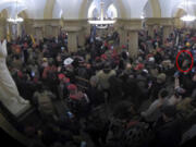 This image from security video of Michael Daniele, a retired New Jersey State Police trooper, seen in the Crypt in the U.S. Capitol on Jan. 6, 2021, was contained in the Justice Department affidavit and complaint in support of the arrest of Daniele.