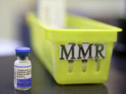 FILE - A vial of a measles, mumps and rubella vaccine sits on a countertop at a pediatrics clinic in Greenbrae, Calif., on Feb. 6, 2015.