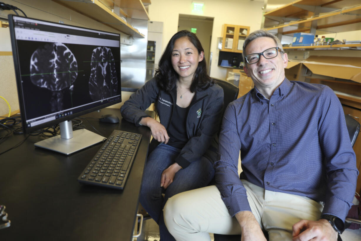 Drs. Erin Yamamoto, left, and Juan Piantino used special imaging to spot a long-suspected pathway the human brain uses to clear waste at Oregon Health &amp; Science University in Portland.