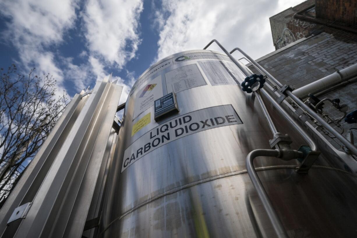 FILE - A liquid carbon dioxide containment unit stands outside the fabrication building of Glenwood Mason Supply Company, April 18, 2023, in the Brooklyn borough of New York.