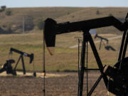 Pumpjacks operate in a pasture, Monday, Sept. 30, 2024, near Hays, Kan.