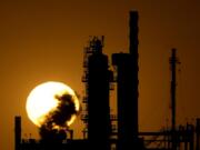 The CHS oil refinery is silhouetted against the setting sun Sept. 28 in McPherson, Kan.