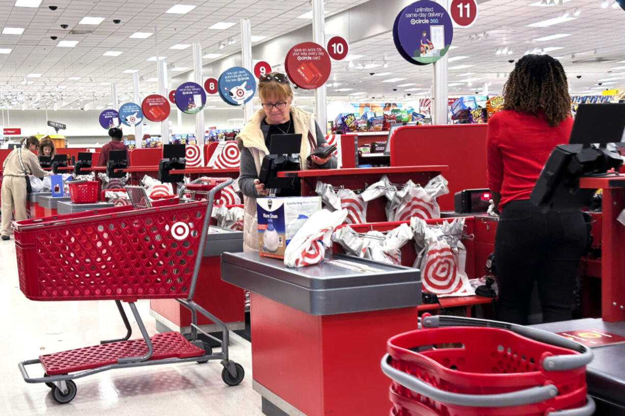 A shopper checks out at a cash register in a grocery store in Glenview, Ill., Sunday, Oct. 27, 2024. (AP Photo/Nam Y.