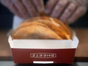 A Sheetz employee prepares a taco order at the convenience store, Thursday, Oct. 17, 2024, in Bethlehem, Pa.