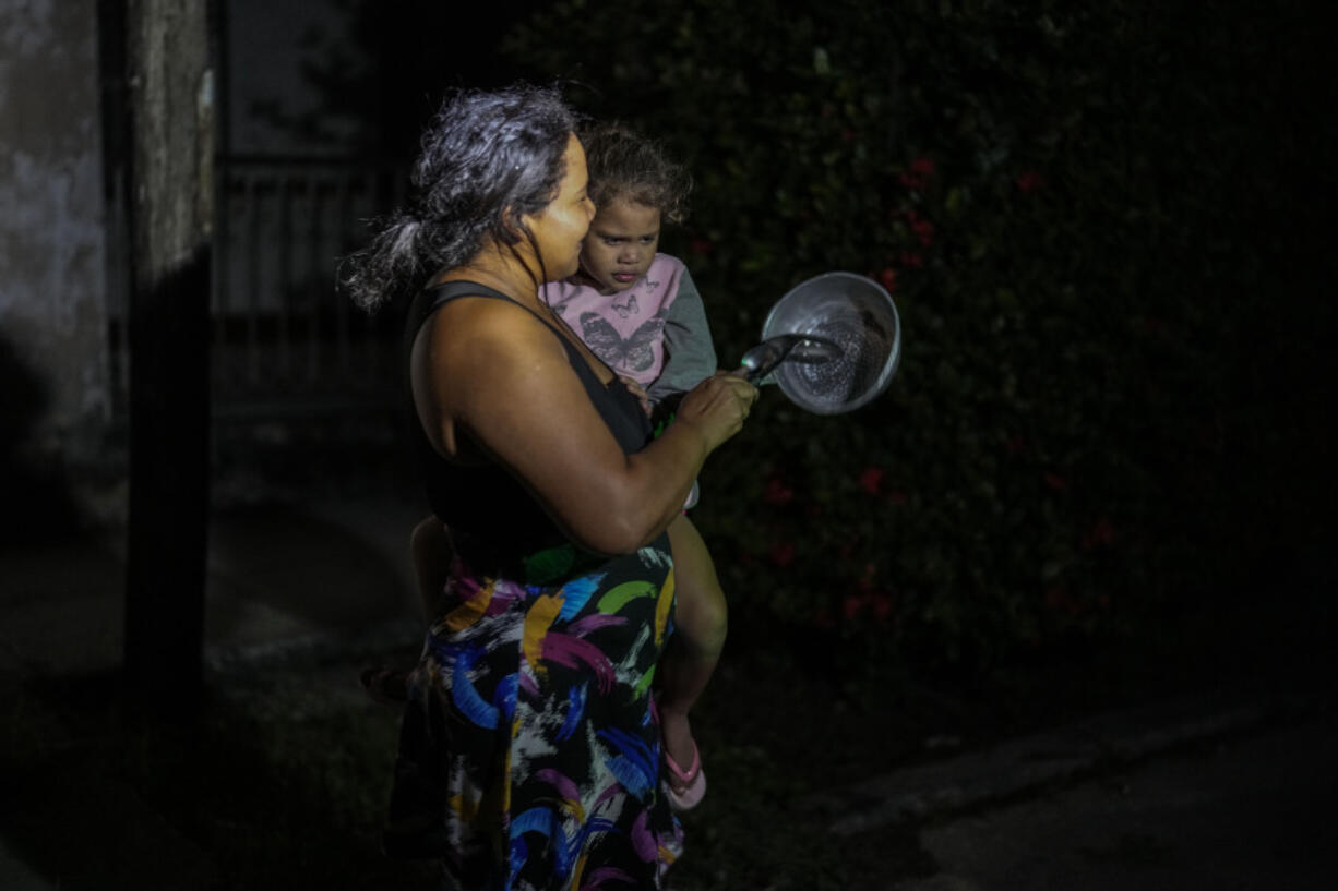 Residents protest by banging pots and pans in Havana, Cuba, Sunday, Oct. 20, 2024.