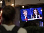 In this image released on Friday, October, 18, 2024,  a person stops to watch a screen displaying the US Presidential debate between Vice President and Democratic presidential candidate Kamala Harris and former US president and Republican presidential candidate Donald Trump in Washington, DC.  HANDOUT IMAGE - Please see Special Instructions. Press release and media available to download at www.apmultimedianewsroom.com/newsaktuell.