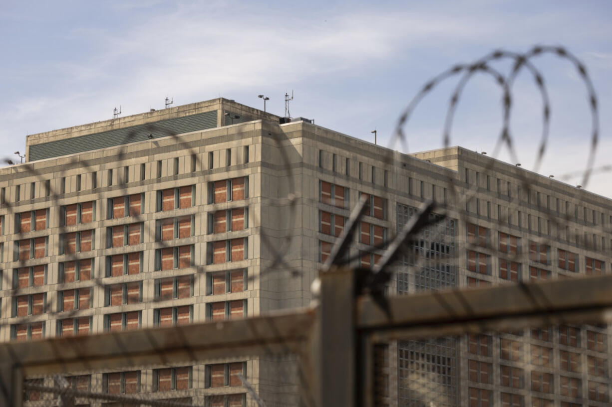 The Metropolitan Detention Center is seen through barb wire in the Sunset Park neighborhood of the Brooklyn borough of New York, Thursday, Sept. 19, 2024.