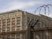 The Metropolitan Detention Center is seen through barb wire in the Sunset Park neighborhood of the Brooklyn borough of New York, Thursday, Sept. 19, 2024.