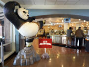 A statue of the DreamWorks Animation character Po, from the &ldquo;Kung Fu Panda&rdquo; films, stands near employees inside the DreamWorks commissary Sept. 25 in Glendale, Calif.