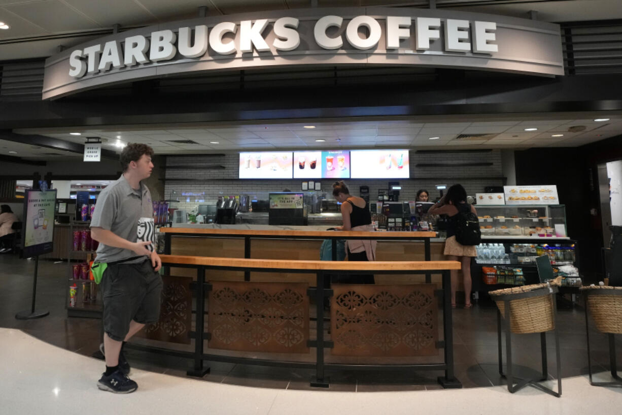 FILE - A patron walks out of a Starbucks at Phoenix Sky Harbor International Airport July 19, 2024, in Phoenix. (AP Photo/Ross D.