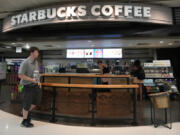 FILE - A patron walks out of a Starbucks at Phoenix Sky Harbor International Airport July 19, 2024, in Phoenix. (AP Photo/Ross D.