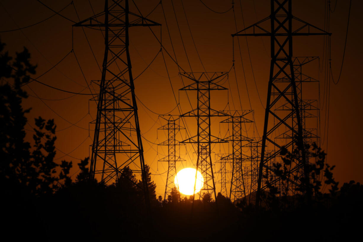 FILE - The sun sets behind high tension power lines on Sept. 23, 2024, in the Porter Ranch section of Los Angeles. (AP Photo/Mark J.