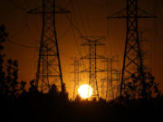 FILE - The sun sets behind high tension power lines on Sept. 23, 2024, in the Porter Ranch section of Los Angeles. (AP Photo/Mark J.