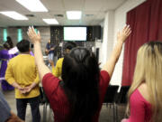 A congregant worships during services at Casa de Adoracion, Sunday, Oct. 27, 2024 in Phoenix.