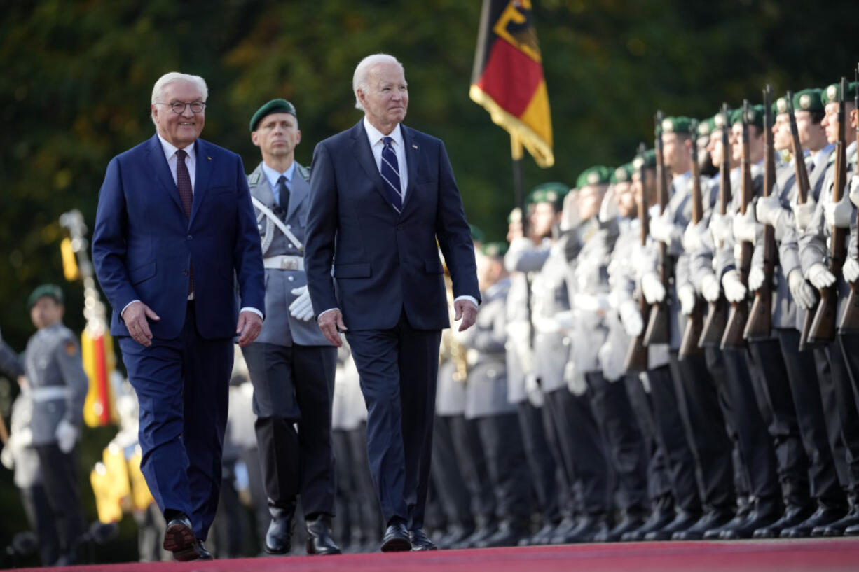 FILE - President Joe Biden and German President Frank-Walter Steinmeier inspect the military honour guard during the welcoming ceremony at Bellevue Palace in Berlin, Germany, on Oct. 18, 2024.