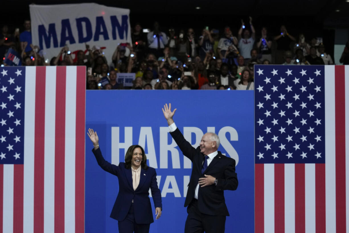 FILE - Democratic presidential nominee Vice President Kamala Harris and her running mate Minnesota Gov. Tim Walz arrive at a campaign rally in Philadelphia, Tuesday, Aug. 6, 2024.