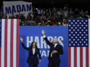 FILE - Democratic presidential nominee Vice President Kamala Harris and her running mate Minnesota Gov. Tim Walz arrive at a campaign rally in Philadelphia, Tuesday, Aug. 6, 2024.