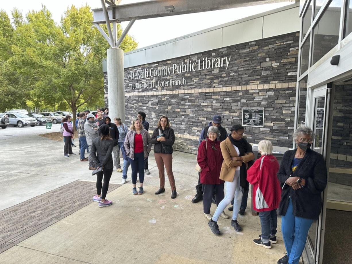 People line up to vote in the Atlanta suburb of Tucker, Ga., on Tuesday, Oct. 15, 2024, the first day of early in-person voting in Georgia.