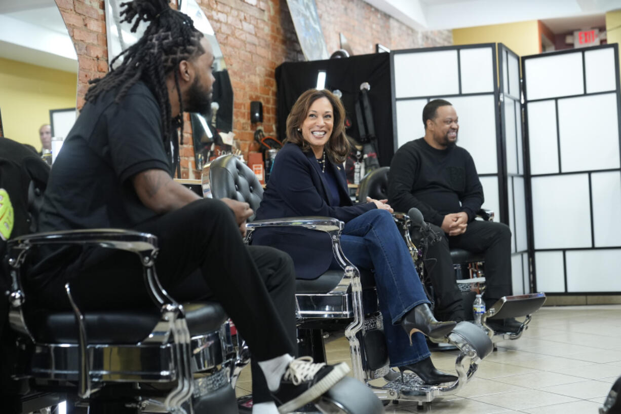 Democratic presidential nominee Vice President Kamala Harris, center, sits in conversation with Black men at Philly Cuts barbershop during a campaign stop, Sunday, Oct. 27, 2024, in Philadelphia.