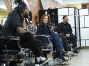 Democratic presidential nominee Vice President Kamala Harris, center, sits in conversation with Black men at Philly Cuts barbershop during a campaign stop, Sunday, Oct. 27, 2024, in Philadelphia.