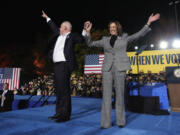 Democratic presidential nominee Vice President Kamala Harris, right, and her running mate Minnesota Gov. Tim Walz depart after speaking during a campaign rally at Burns Park in Ann Arbor, Mich., Monday, Oct. 28, 2024.