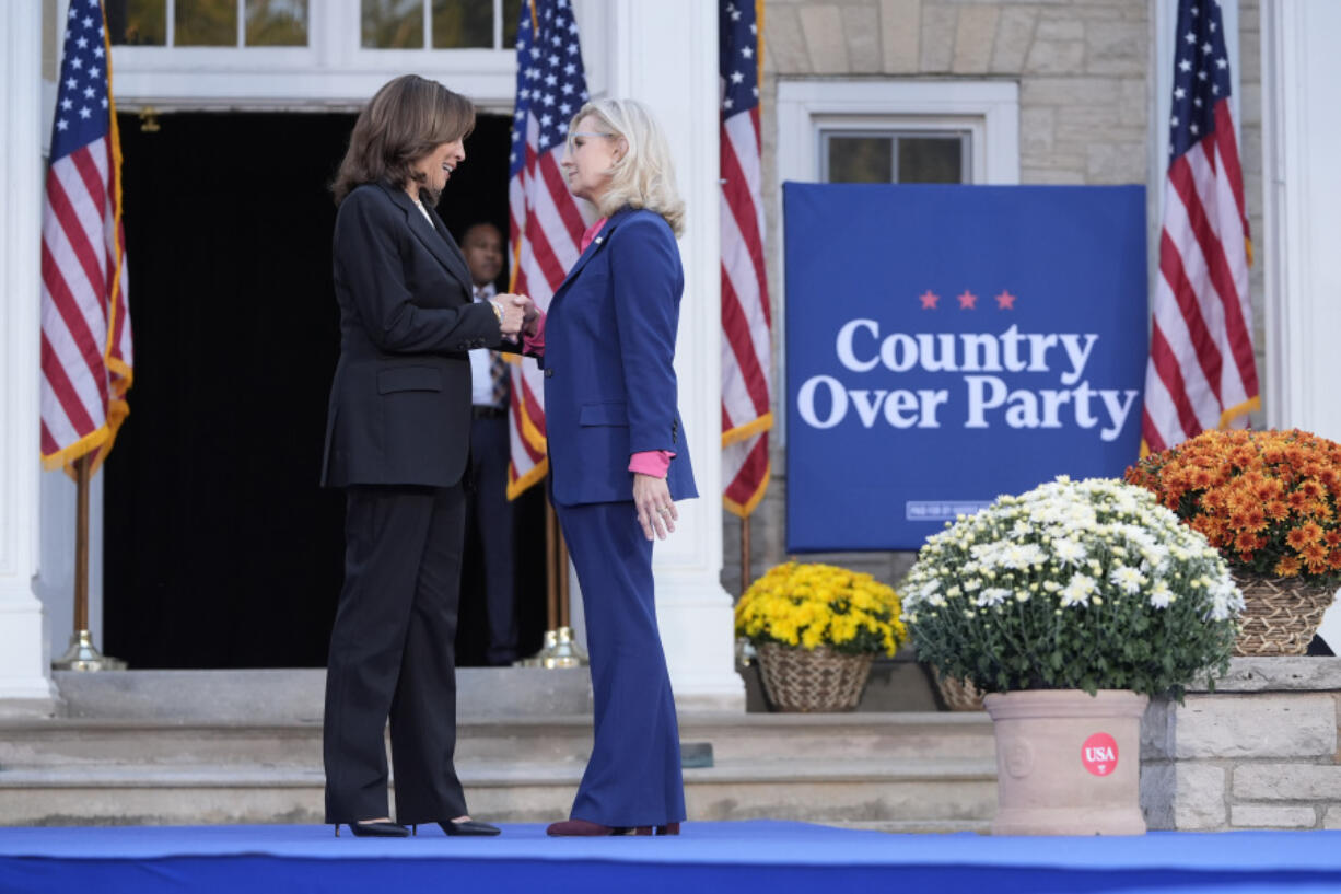 Democratic presidential nominee Vice President Kamala Harris, left, is greeted by former Congresswoman Liz Cheney, R-Wyo., during a campaign event at Ripon College in Ripon, Wis., Thursday, Oct. 3, 2024.