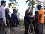 Democratic presidential nominee Vice President Kamala Harris greets people who were impacted by Hurricane Helene in Augusta, Ga., Wednesday, Oct. 2, 2024, as from left, Sen. Jon Ossoff, D-Ga., FEMA deputy direct Erik Hooks and Augusta Mayor Garnett Johnson watch.