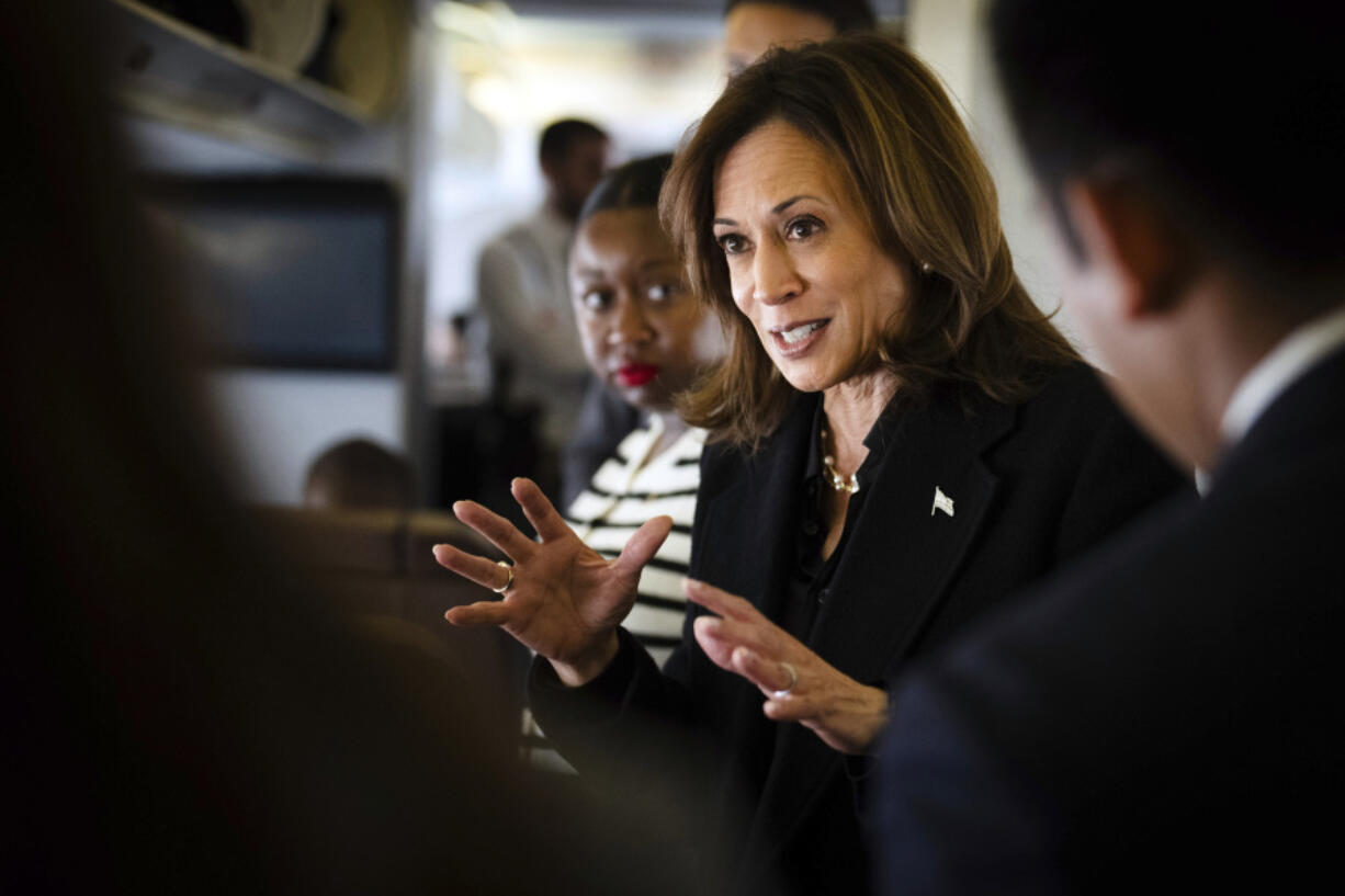 Democratic presidential candidate Vice President Kamala Harris talks to reporters aboard Air Force Two at Joint Base Andrews, Md., Wednesday, Oct. 23, 2024.