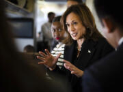 Democratic presidential candidate Vice President Kamala Harris talks to reporters aboard Air Force Two at Joint Base Andrews, Md., Wednesday, Oct. 23, 2024.