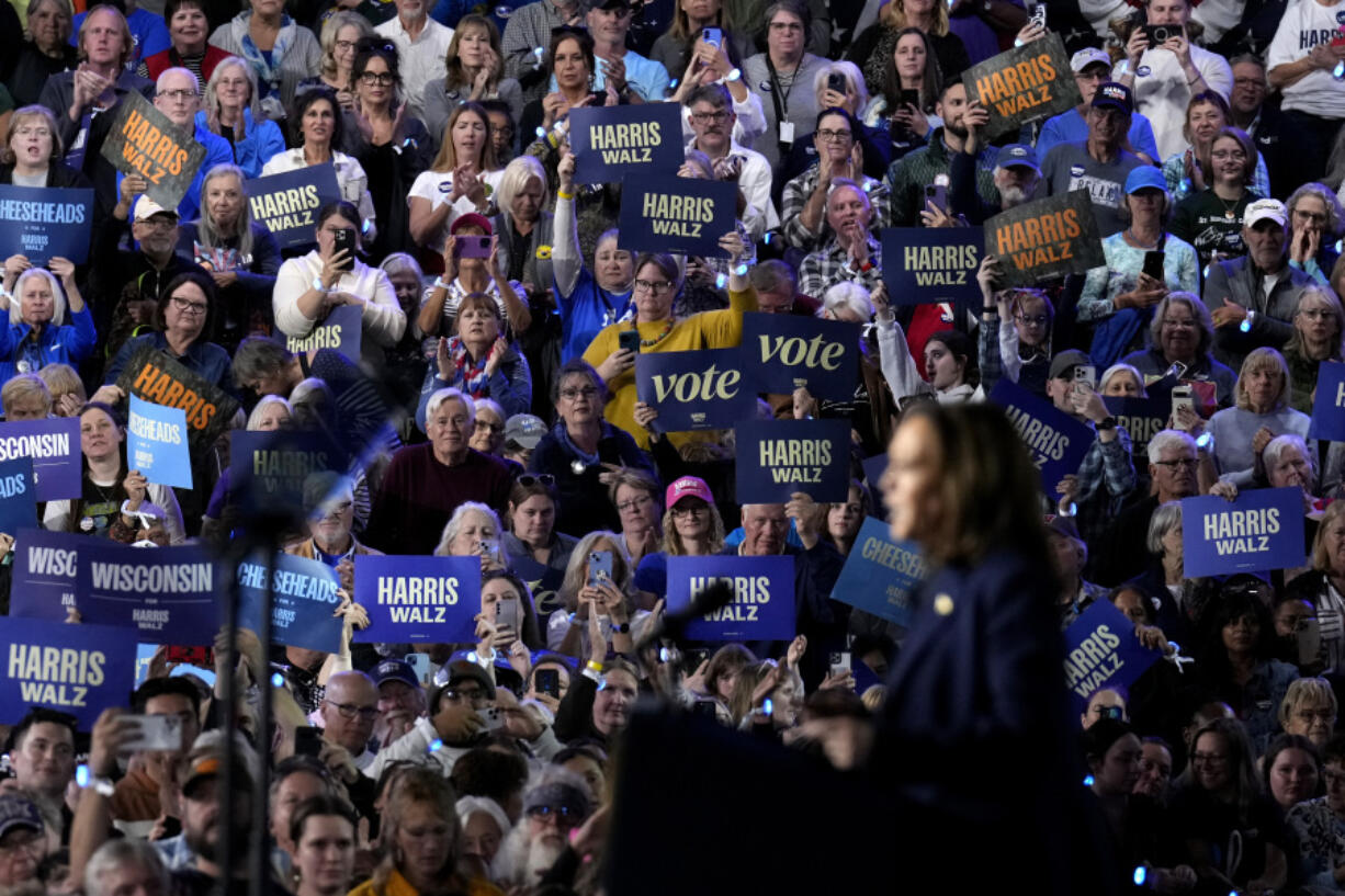 Attendees listen as Democratic presidential nominee Vice President Kamala Harris speaks at a campaign rally at the Resch Expo in Green Bay, Wis., Thursday, Oct. 17, 2024.