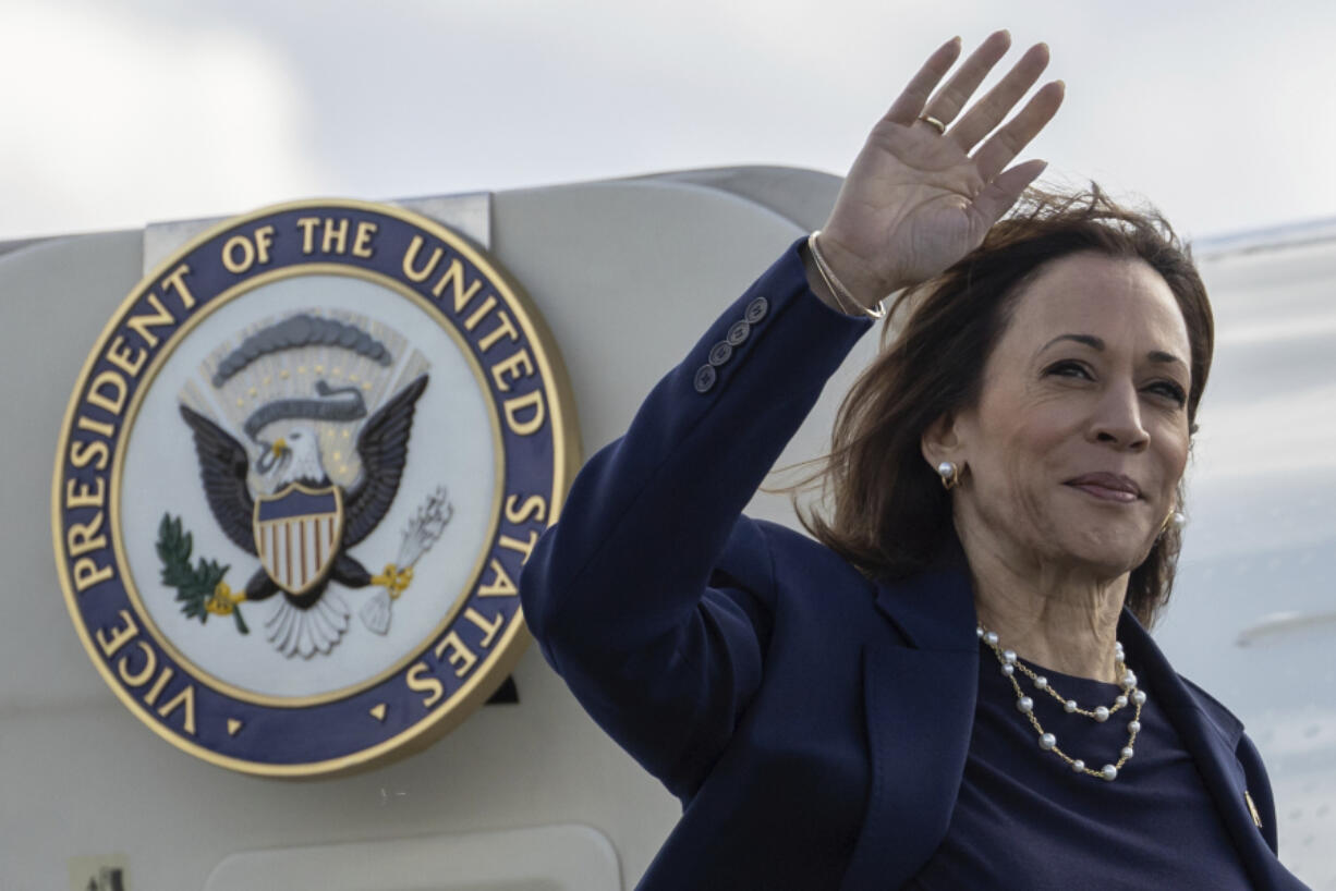 Democratic presidential nominee Vice President Kamala Harris waves as she boards Air Force Two at LaGuardia International Airport, Wednesday, Oct. 9, 2024, in New York.