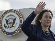 Democratic presidential nominee Vice President Kamala Harris waves as she boards Air Force Two at LaGuardia International Airport, Wednesday, Oct. 9, 2024, in New York.