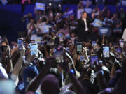 Attendees take photos and record video on their cell phones as Democratic presidential nominee Vice President Kamala Harris speaks during a campaign event at East Carolina University, Sunday, Oct. 13, 2024, in Greenville, N.C.