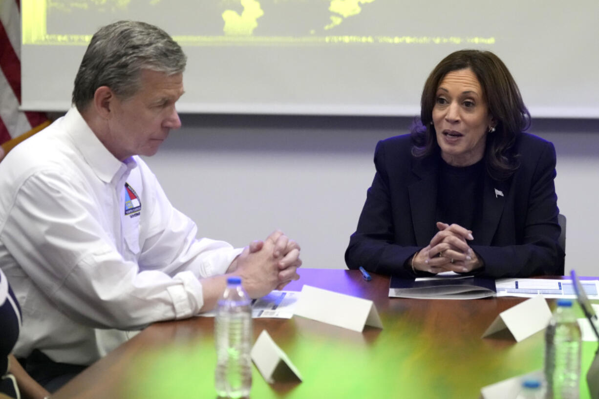 Democratic presidential nominee Vice President Kamala Harris, right, receives a briefing from North Carolina Gov. Roy Cooper on the damage from Hurricane Helene, Saturday, October 5, 2024 in Charlotte, N.C.