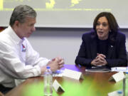 Democratic presidential nominee Vice President Kamala Harris, right, receives a briefing from North Carolina Gov. Roy Cooper on the damage from Hurricane Helene, Saturday, October 5, 2024 in Charlotte, N.C.