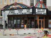 People walk past a theatre in Waukegan, Ill., Saturday, Sept. 28, 2024. (AP Photo/Nam Y.