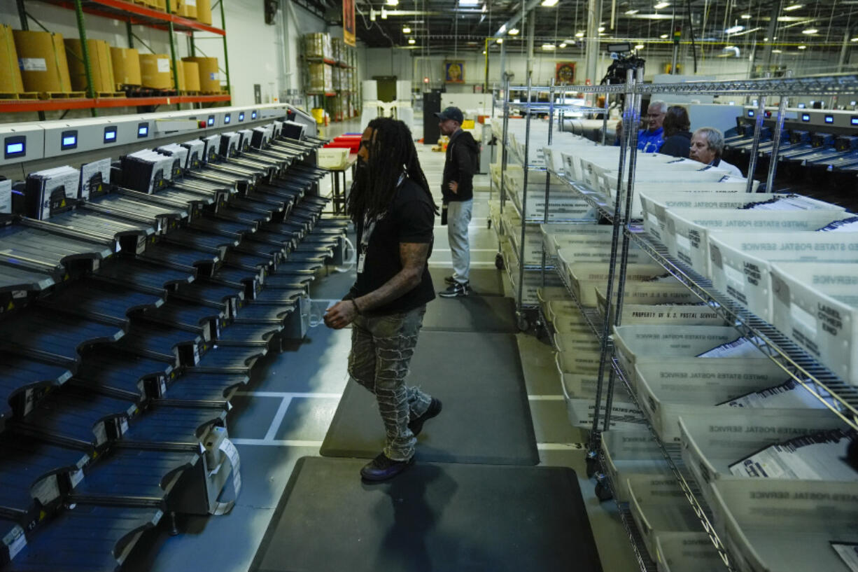 Election workers demonstrates mail-in ballot processing during a media preview at the Philadelphia Election Warehouse, in Philadelphia, Friday, Oct. 25, 2024.