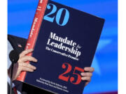 A copy of Project 2025 is held during the Democratic National Convention, Aug. 21, 2024, in Chicago. For a year, Project 2025 has endured as a persistent force in the presidential election. It&rsquo;s rare for a complex 900-page policy book to figure so dominantly in a political campaign. (AP Photo/J.