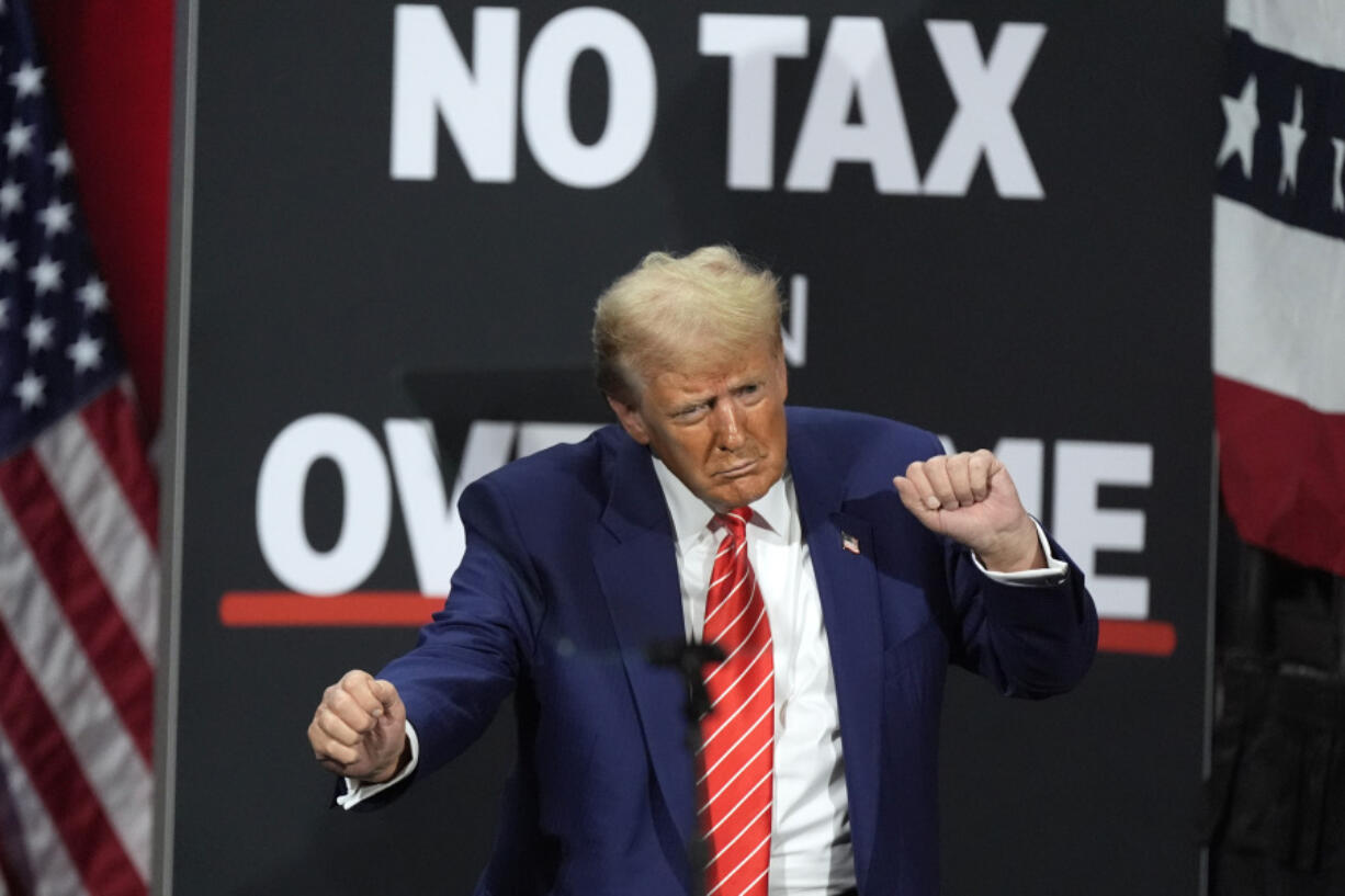 Republican presidential nominee former President Donald Trump dances at a campaign event at the Cobb Energy Performing Arts Centre, Tuesday, Oct. 15, 2024, in Atlanta.