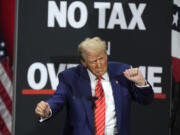 Republican presidential nominee former President Donald Trump dances at a campaign event at the Cobb Energy Performing Arts Centre, Tuesday, Oct. 15, 2024, in Atlanta.