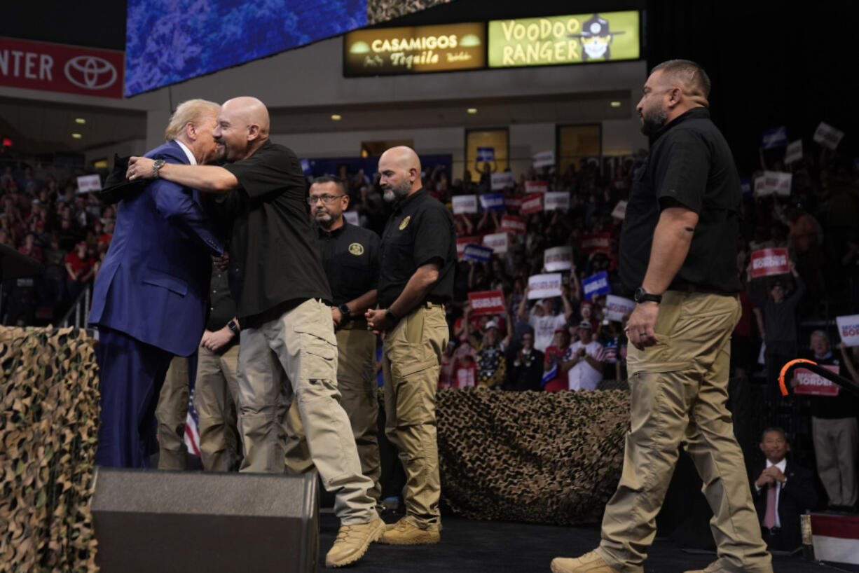 Republican presidential nominee former President Donald Trump greets members of the U.S. Border Patrol as he speaks at a campaign rally at the Findlay Toyota Arena Sunday, Oct. 13, 2024, in Prescott Valley, Ariz.