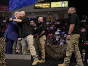 Republican presidential nominee former President Donald Trump greets members of the U.S. Border Patrol as he speaks at a campaign rally at the Findlay Toyota Arena Sunday, Oct. 13, 2024, in Prescott Valley, Ariz.