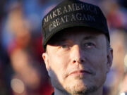 Tesla and SpaceX CEO Elon Musk listens as Republican presidential nominee former President Donald Trump speaks at a campaign event at the Butler Farm Show, Saturday, Oct. 5, 2024, in Butler, Pa.