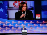 A video plays of Democratic presidential nominee Vice President Kamala Harris speaking during a town hall as Republican presidential nominee former President Donald Trump listens during a campaign rally at Thomas &amp; Mack Center, Thursday, Oct. 24, 2024, in Las Vegas.